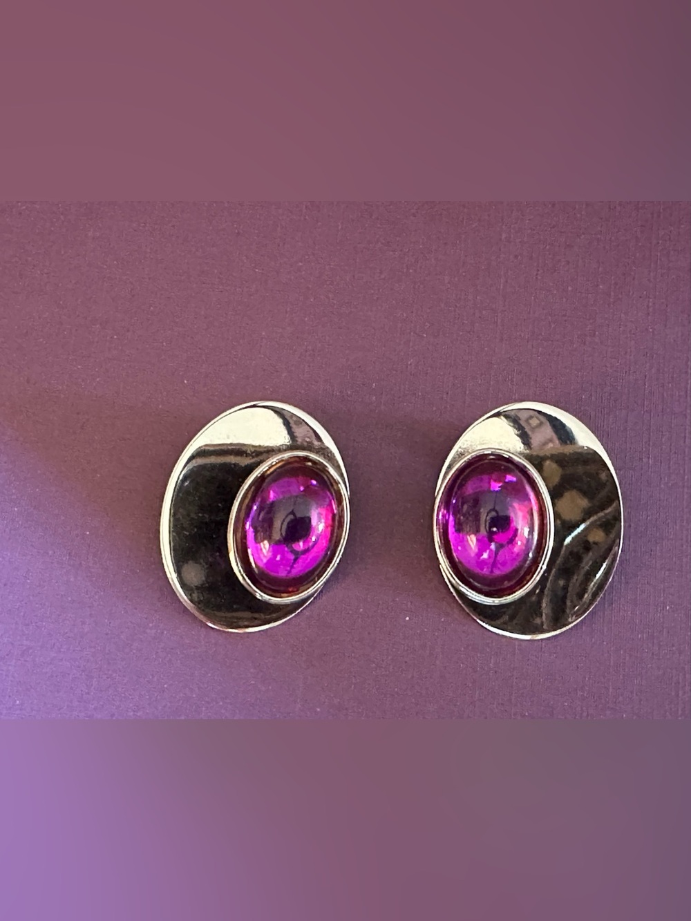 Vintage Clip on silver-tone earrings with purple cabochon stones.
